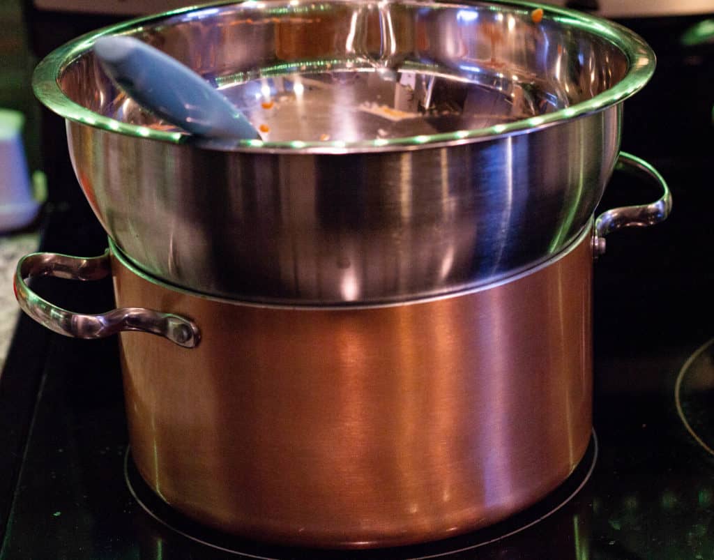 Cooking the Pumpkin Mousse mixture over a pot of simmering water