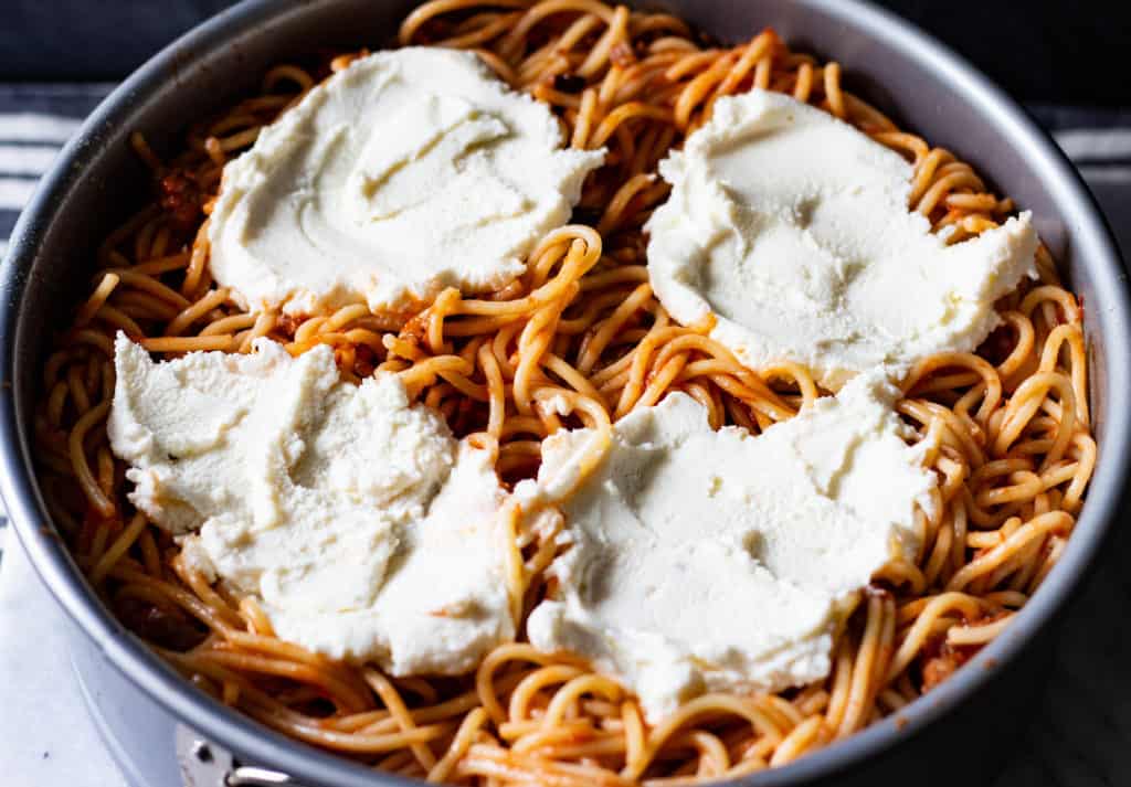 Dollops of Ricotta Cheese on Top of Spaghetti Mixture_2
