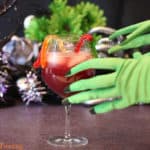 Sangria in glass with witchy hands