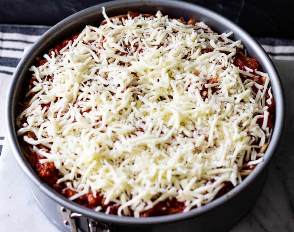 Shredded Mozarella Cheese Covering Sausage Sauce